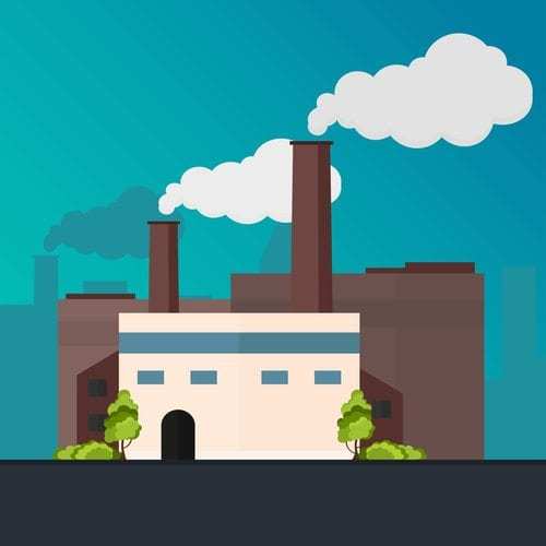 industrial manufacturing building with smoke floating from chimneys