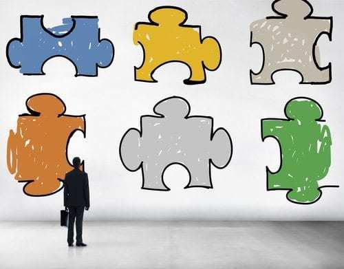 Man Looking at Puzzle Pieces - Work Teamwork Concept